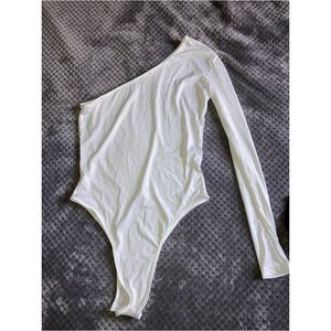 White, one armed body suit.